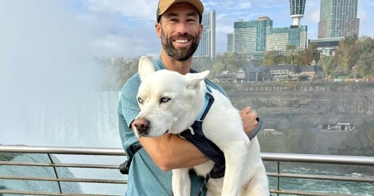 A reluctant Rhea poses for a family picture at Niagara Falls